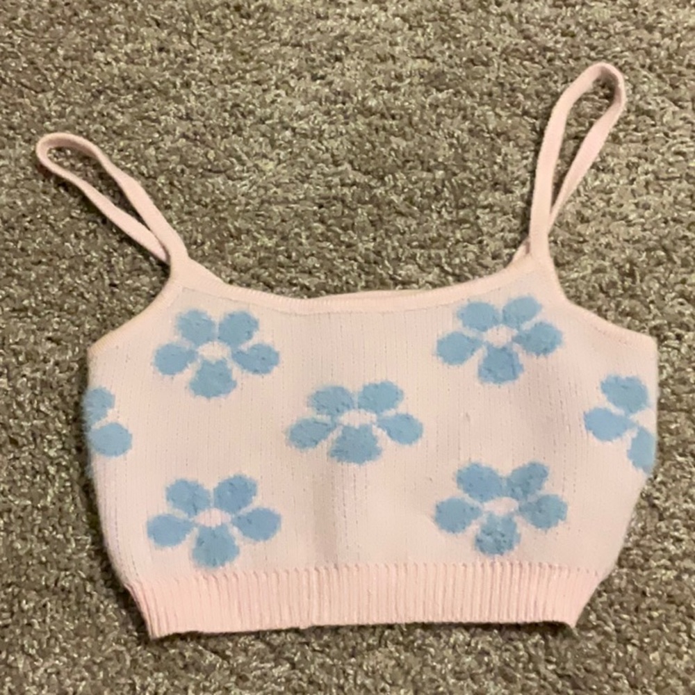 Pink fuzzy tank top with blue flowers.